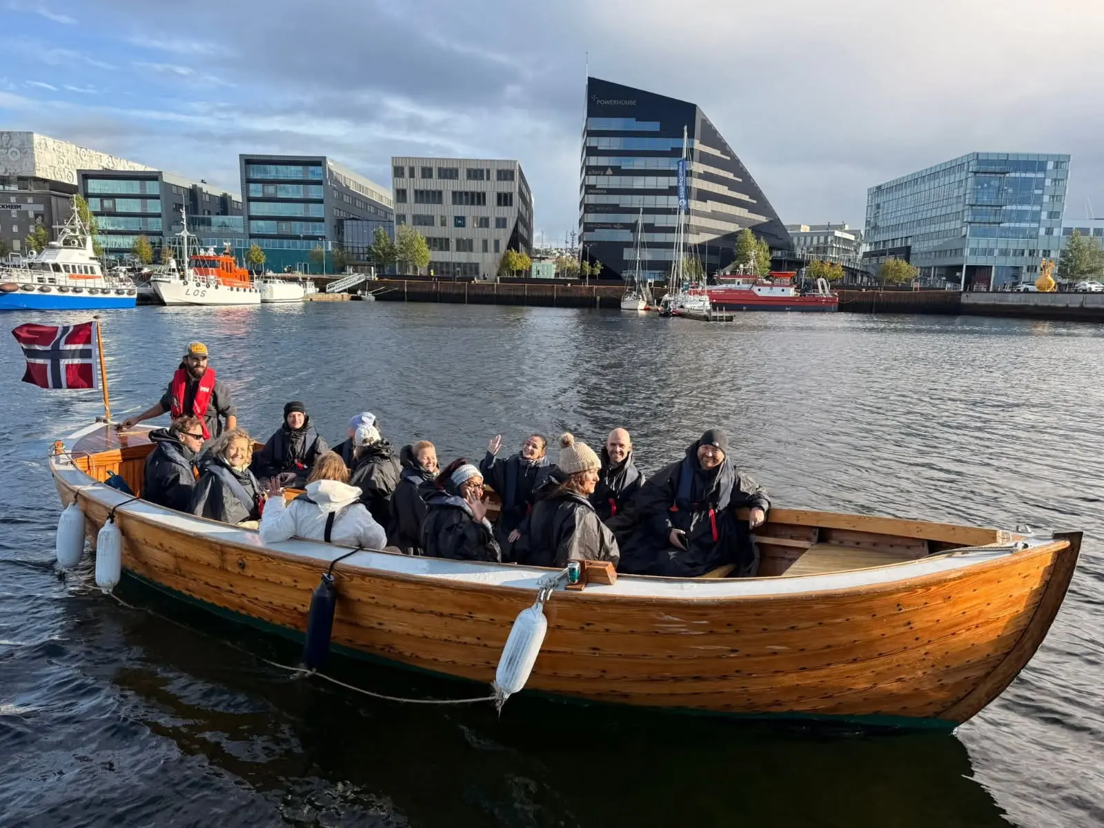 Rino welcoming passengers aboard the traditional wooden boat Bylgja in Trondheim